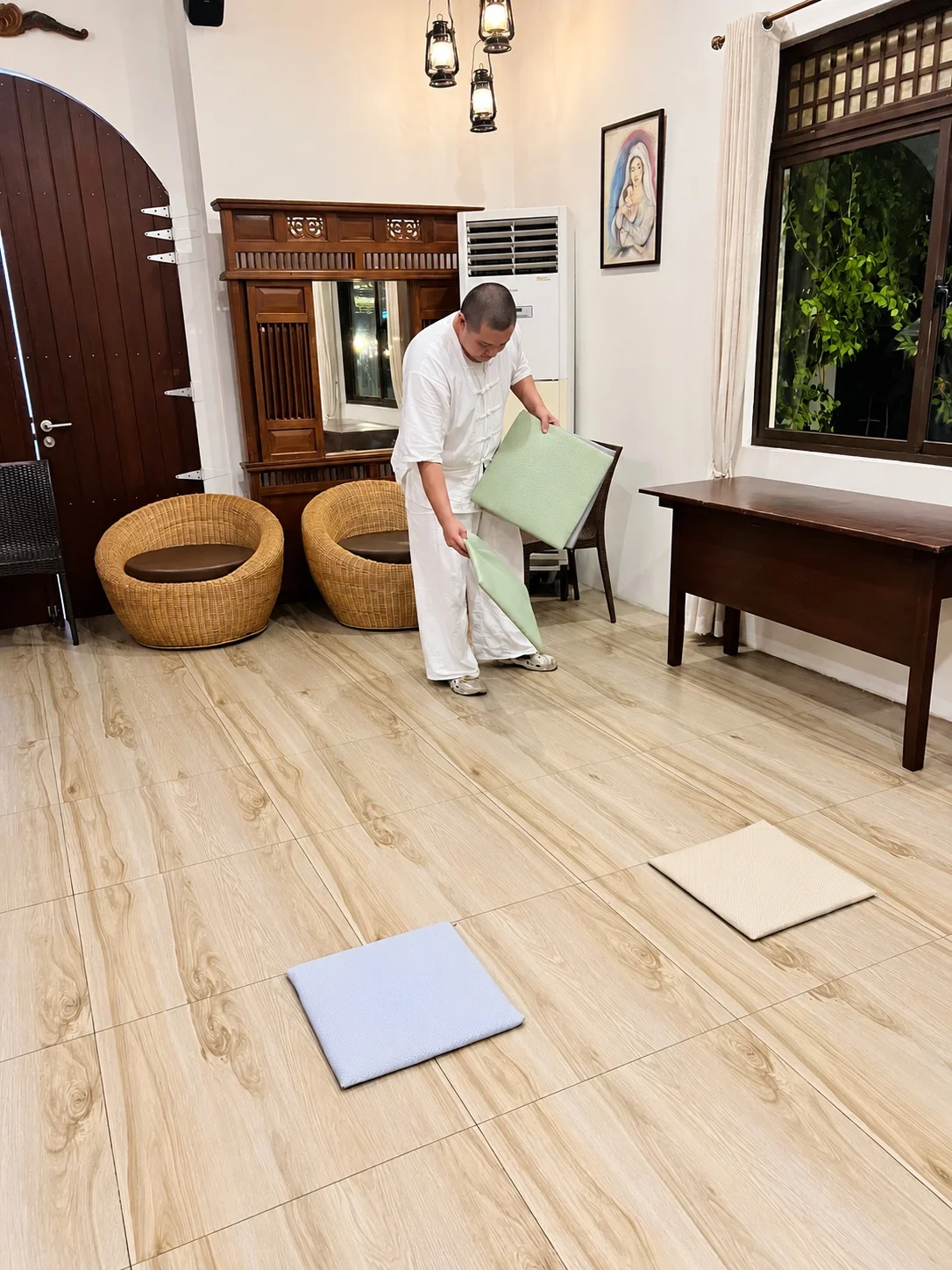 Preparing cushions for a meditation session at Balai Belen